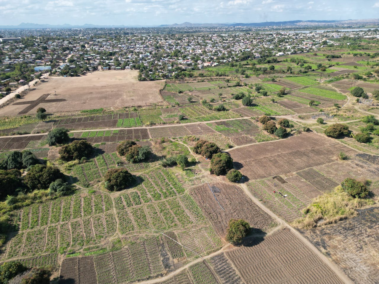 Home Expansive aerial view showcasing agricultural fields and rural landscape near Lilongwe, Malawi.
